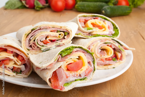 wrapped tortilla sandwich rolls cut in half and ingredients