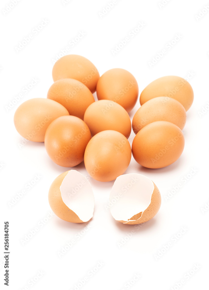 A cracked and open egg in front of other eggs A cracked and open egg in front of other eggs