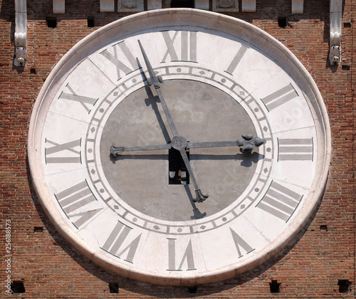 Clock on Torre dei Lamberti - medieval tower of the Lamberti XI century - 84 m. Piazza delle Erbe, UNESCO world heritage site in Verona, Italy