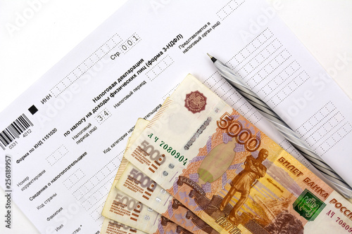 Russian documents, income Declaration Form 3-NDFL, cash 5000 rubles and a pen.