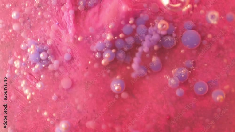 Bubbles blue watercolor on pink paint in oil Bubbles blue watercolor on pink paint in oil