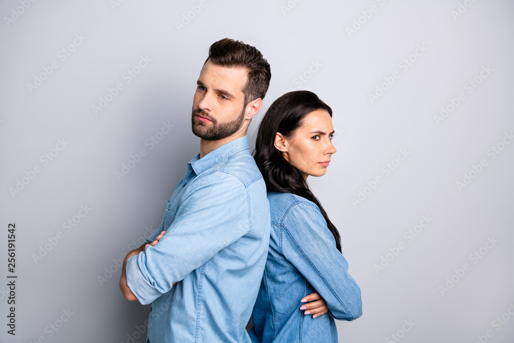 Family drama. Portrait of unhappy married person people ignoring irritated having scandals standing back to back wearing denim shirts isolated on grey background Family drama. Portrait of unhappy married person people ignoring irritated having scandals standing back to back wearing denim shirts isolated on grey background