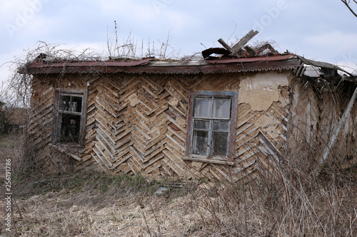 Destroyed house without a roof in an abandoned village.