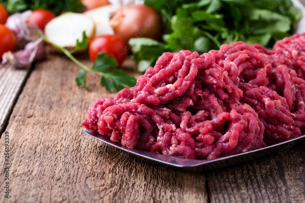 Minced beef, raw ground meat with cooking ingredients Minced beef, raw ground meat with cooking ingredients