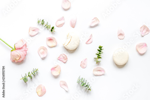 woman table with rose and macaroons in pastel color top view mockup