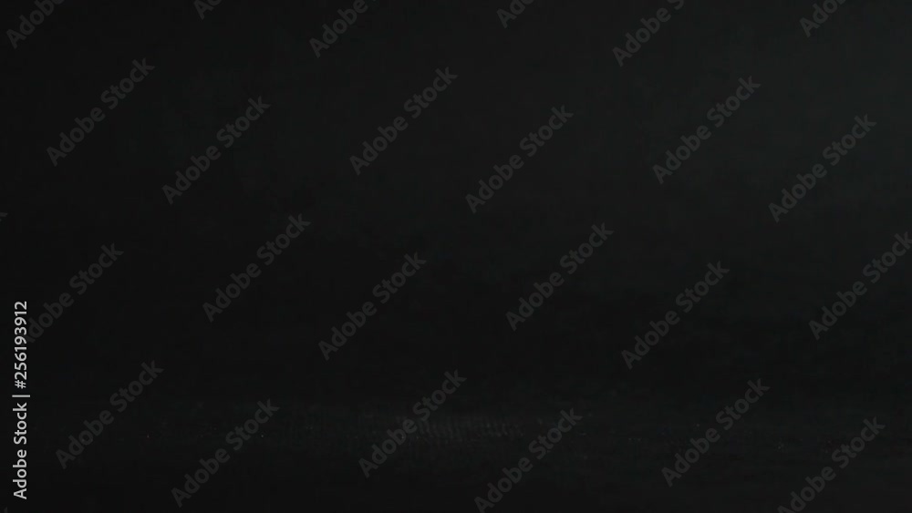 Egg are slowly rolling on the black table. Easter eggs background. Close up. Egg are slowly rolling on the black table. Easter eggs background. Close up.