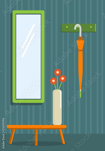 The interior of the entrance hall of the apartment with a table, a hanger and a mirror.