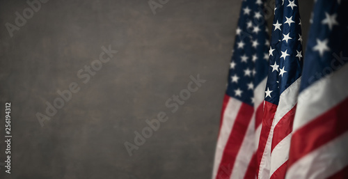 American flags over gray wall, 4th of july panoramic background with copy space