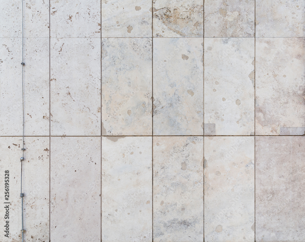 Full frame background of a modern and a bit broken wall or building exterior made of abstract stone slabs. Full frame background of a modern and a bit broken wall or building exterior made of abstract stone slabs.