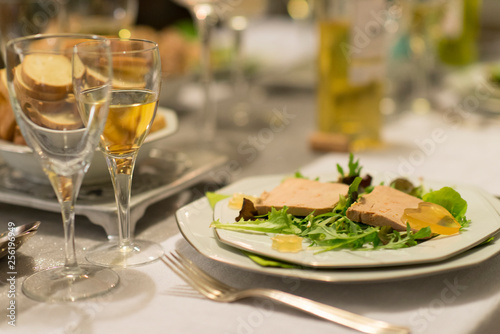Foie gras on salad and sweet white wine for christmas diner is a french speciality for festive Christmas celebration