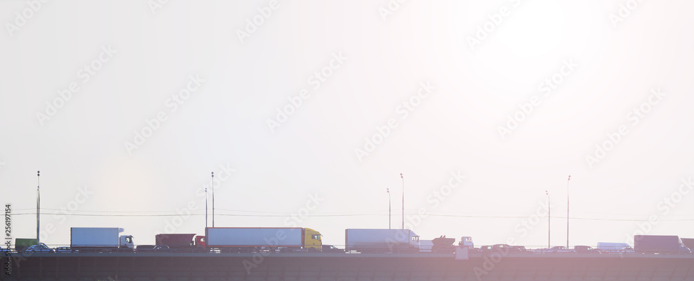 Fototapeta premium Traffic jam on the bridge at sunset, panoramic view. Transport background