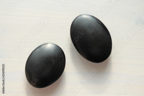 Black stones jet, agate, shungite. Photos for the spa. Black stones on a white background. Zen photo