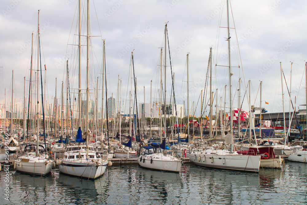 Yachts and boats at the sea harbor in the evening, Barcelona, Spain