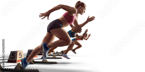 Isolated Female athletes sprinting. Women in sport clothes on starting line prepares to run on white background photo