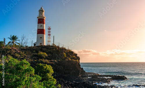 lighthouse on a cliff during sunset in albion, mauritius photo