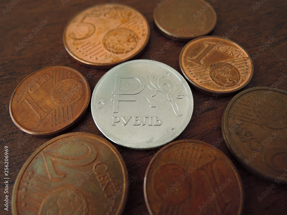 The ruble coin is surrounded by Euro coins The ruble coin is surrounded by Euro coins