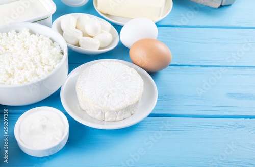 dairy products on blue wooden background, top view