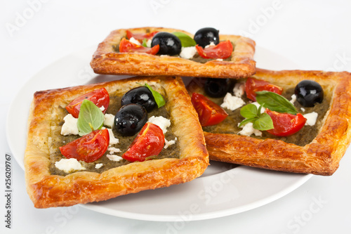 Mediterranean puff pastry with pesto, cherry tomatoes, olives and feta cheese