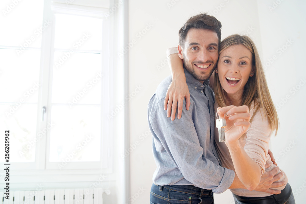 Happy couple with keys to new home Happy couple with keys to new home