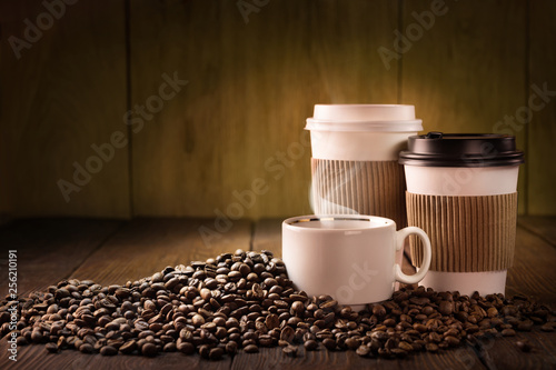Coffee cup and coffee beans on wooden table