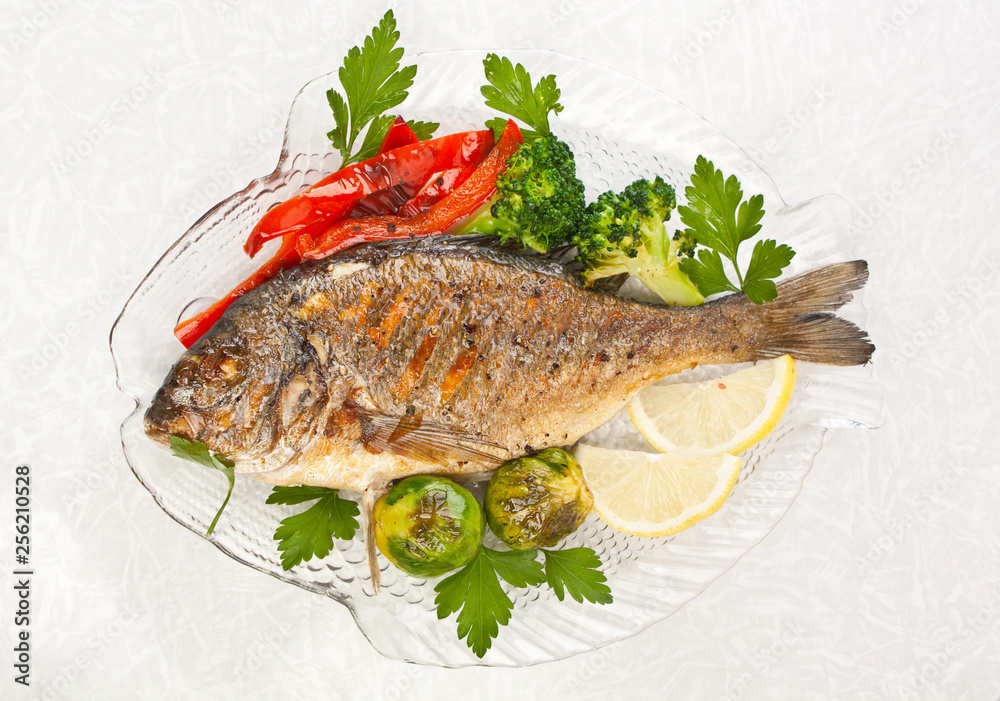 Grilled dorade fish with vegetables, herbs and lemon Grilled dorade fish with vegetables, herbs and lemon
