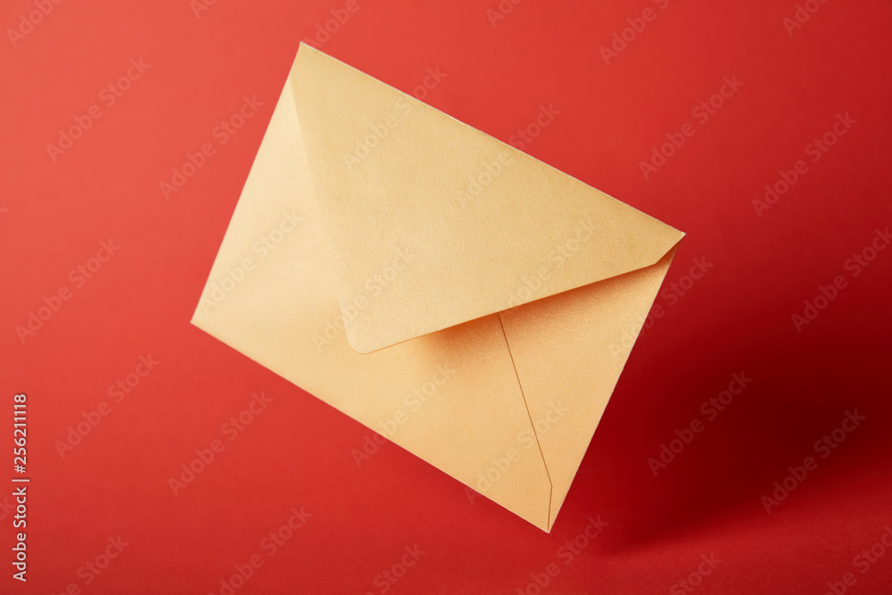 bright, colorful and yellow envelope on red background with copy space bright, colorful and yellow envelope on red background with copy space