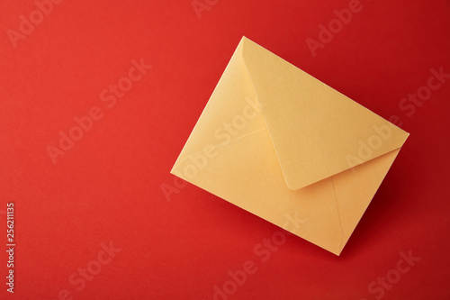 bright, colorful and yellow envelope on red background with copy space