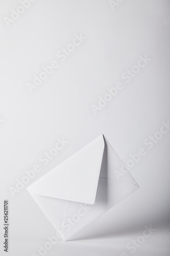 white and empty envelope on grey background with copy space