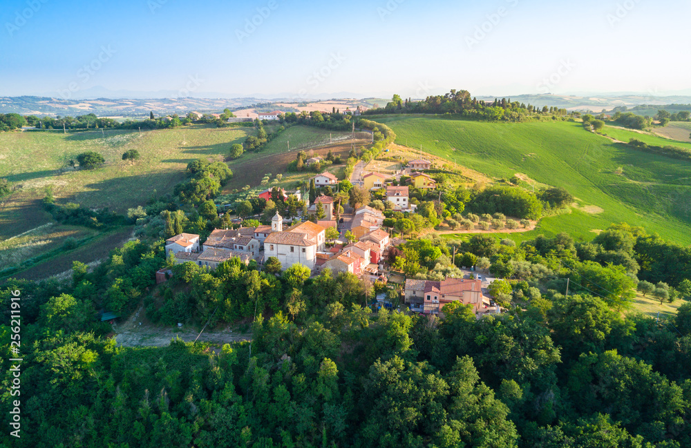 aerial view of a little town located in the italian countryside hills