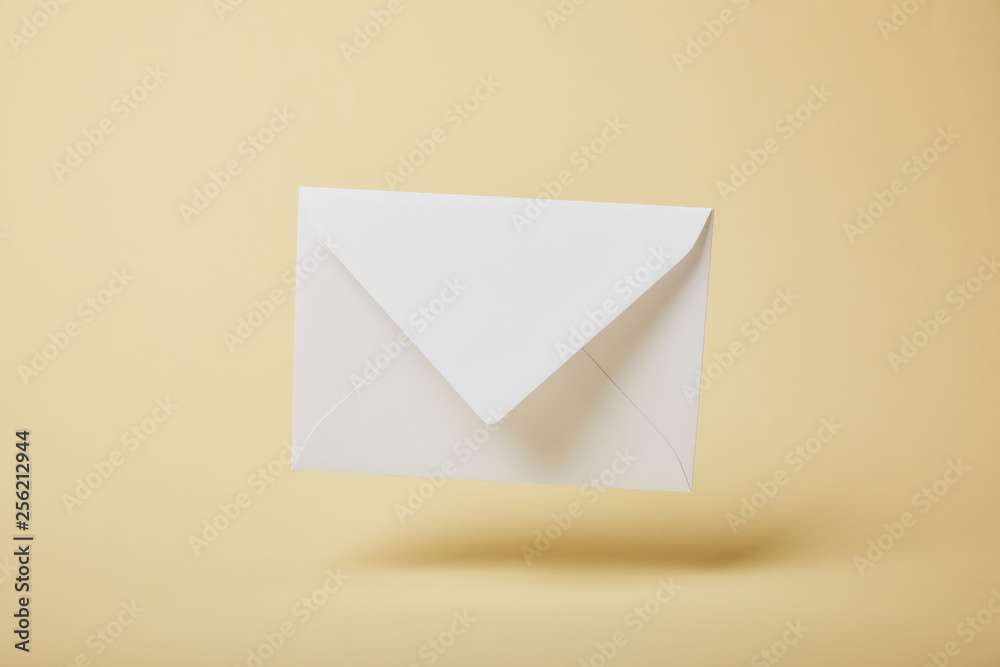 white and empty envelope on yellow background with copy space white and empty envelope on yellow background with copy space