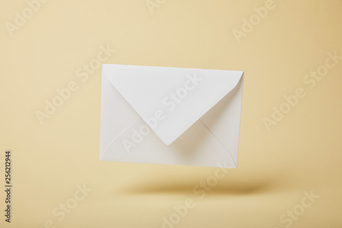 white and empty envelope on yellow background with copy space