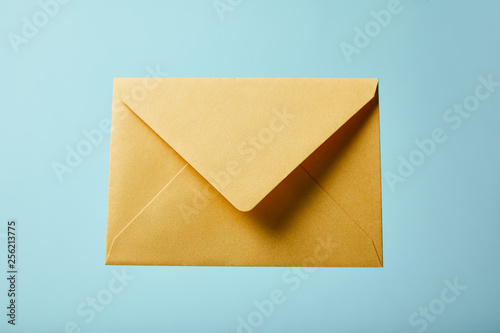 yellow and colorful envelope on blue background with copy space