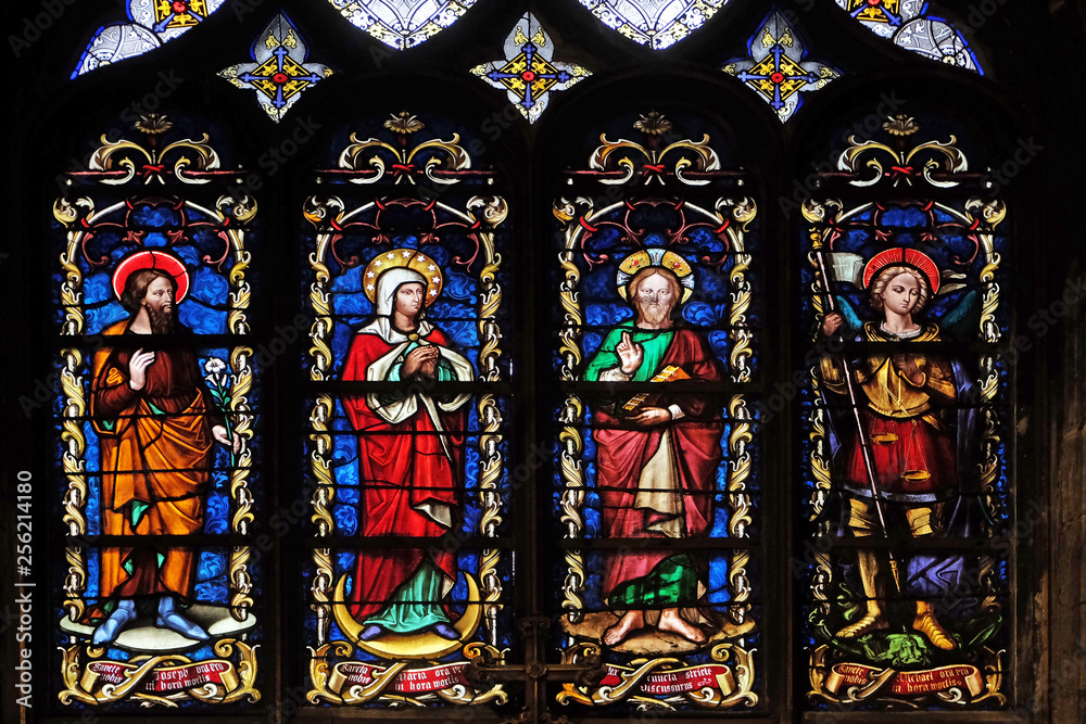 Saint Joseph, Mary, Jesus and Archangel Michael, stained glass window from Saint Germain-l'Auxerrois church in Paris, France