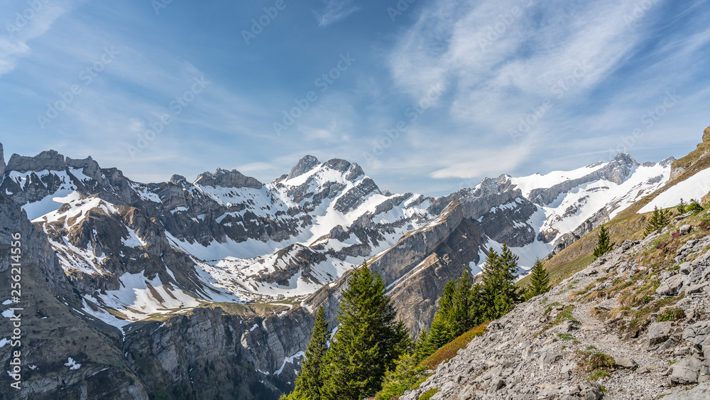 Switzerland, Beautiful scenic view on snow Alps peaks with blue sky and white clouds above