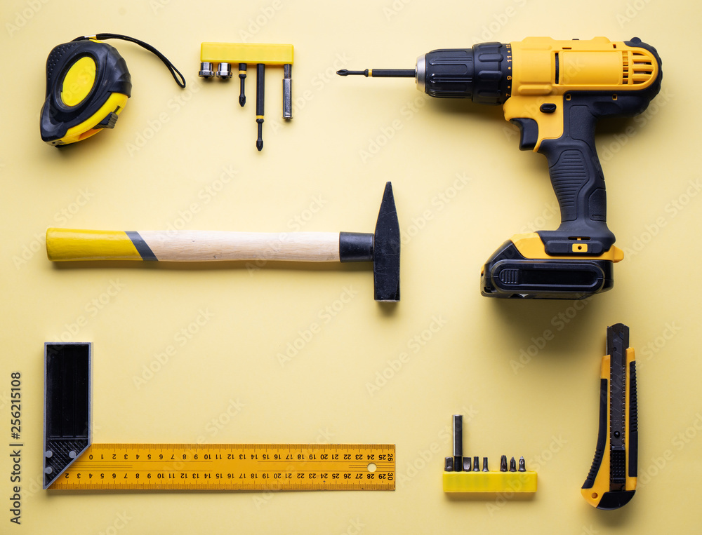 Flat layout of yellow hand tools on a yellow background. Flat layout of yellow hand tools on a yellow background.