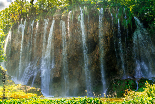 10mt waterfall surrounded by forest during a sunny day  plitvice lakes national park  croatia