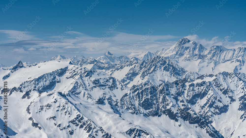 Obraz premium Switzerland, panorama view from Titlis mountain on Alps and mountains above white clouds