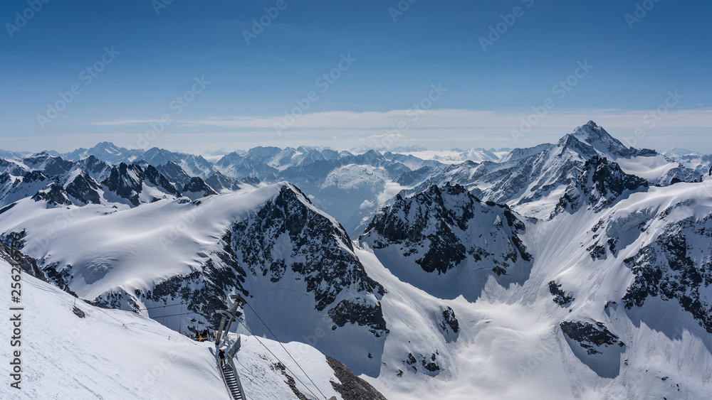 Switzerland, panorama view from Titlis mountain on Alps and mountains above white clouds