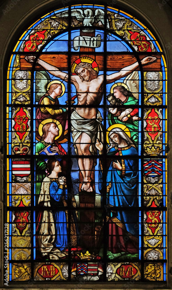 The Crucifixion by Lusson, central stained glass window in the Basilica of Notre Dame des Victoires in Paris, France 