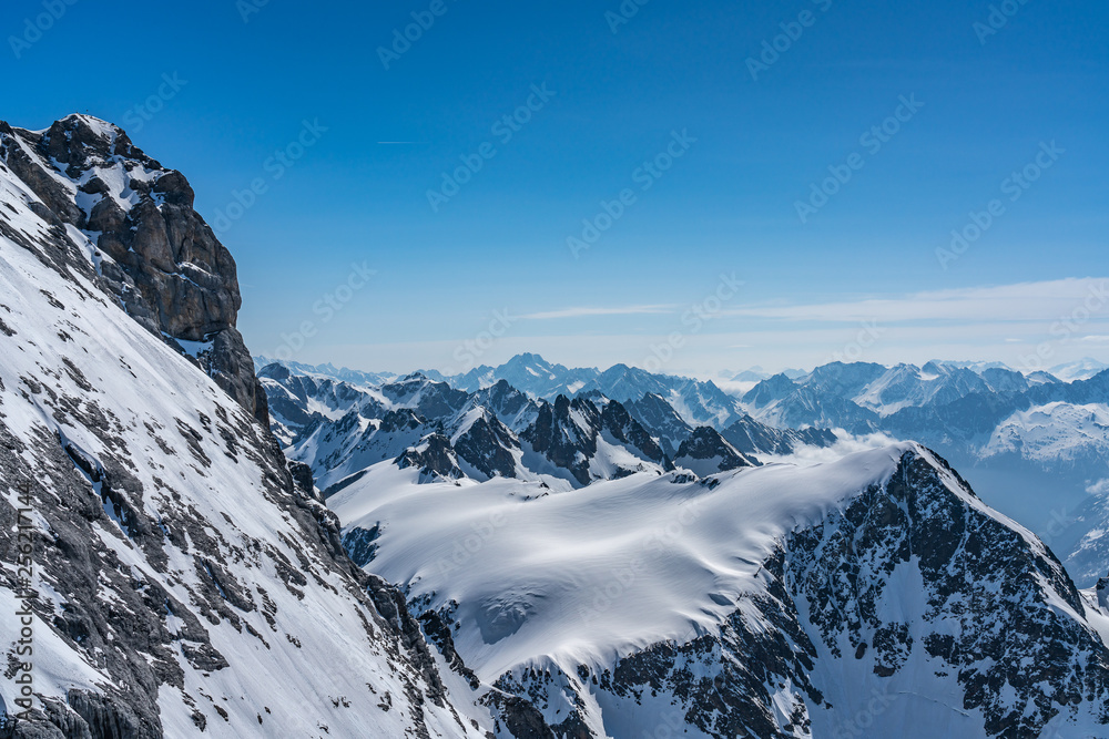 Switzerland, panorama view from Titlis mountain on Alps and mountains above white clouds