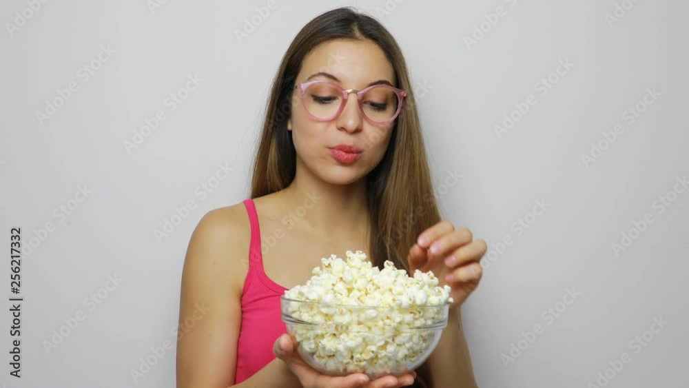 Young woman with glasses eating pop corn Young woman with glasses eating pop corn