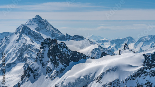 Switzerland, panorama view from Titlis mountain on Alps and mountains above white clouds © AlehAlisevich