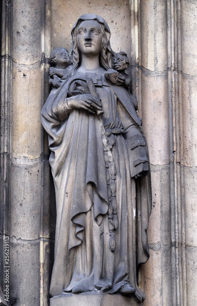 Sainte Genevieve, statue on the portal of the Saint Nicholas des Champs Church, Paris, France