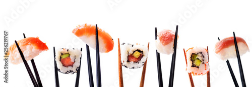 Creative sushi rolls on bamboo chopstick isolated on white background. Japanese luxury cuisine menu. photo