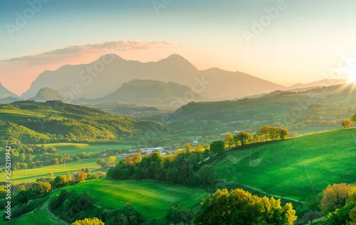 Fototapeta Naklejka Na Ścianę i Meble -  beautiful green mountains and hills landscape at sunset in italy, marche