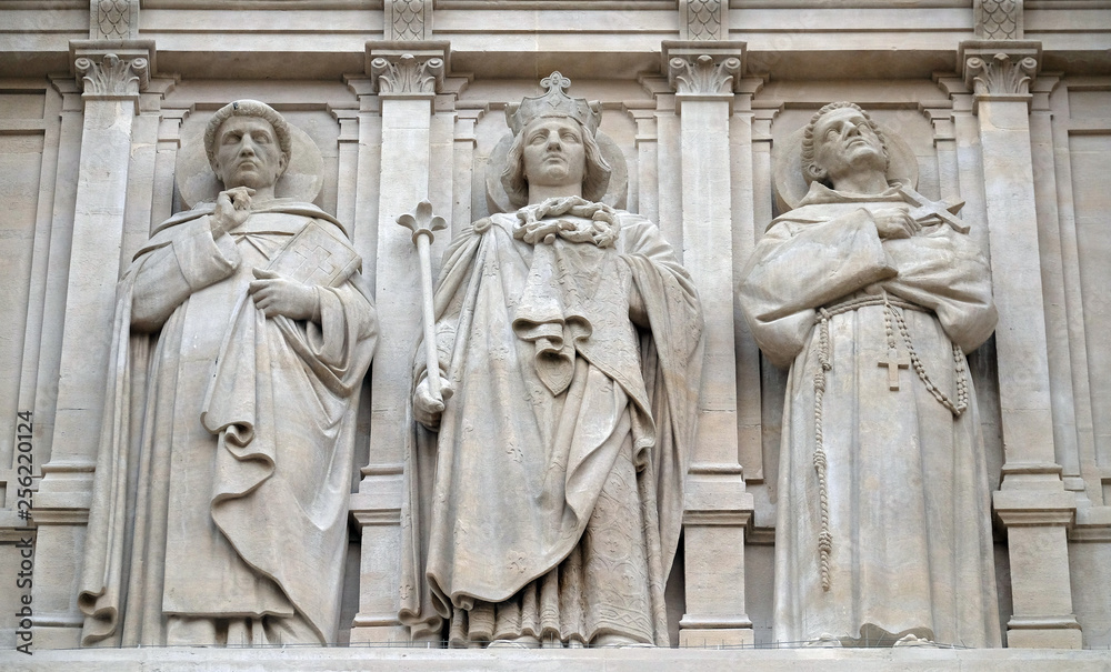 Saints Dominic, Louis and Francis of Assisi, statue on the facade of Saint Augustine church in Paris, France 