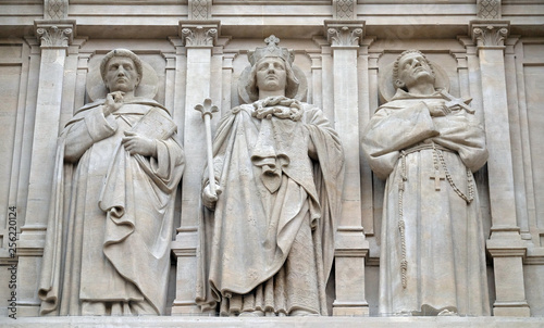 Saints Dominic, Louis and Francis of Assisi, statue on the facade of Saint Augustine church in Paris, France 