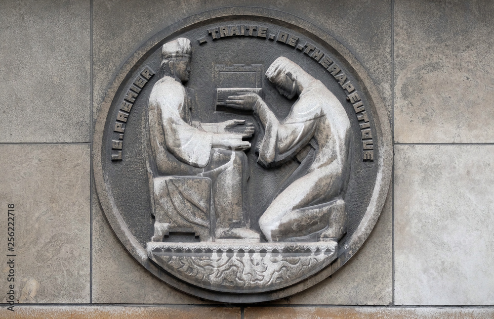 The first therapeutic treatise. Stone relief at the building of the Faculte de Medicine Paris, France