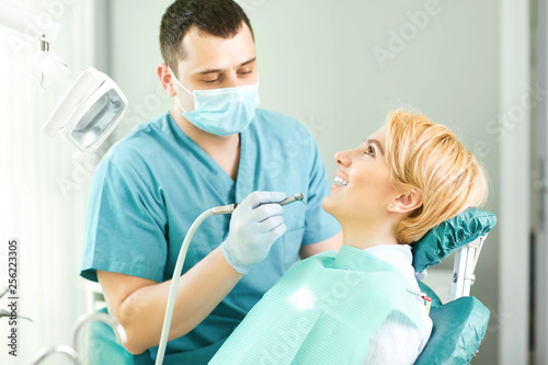 Dentist treats the teeth of the patient girl