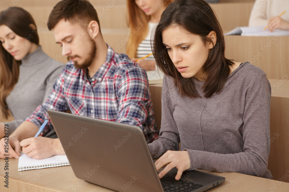 Students using laptop to complete an assignment Students using laptop to complete an assignment